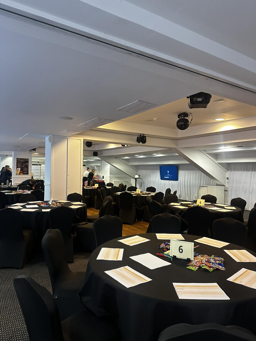 Boardroom event waiting to happen. Caterers in the background setting up the room for the event.